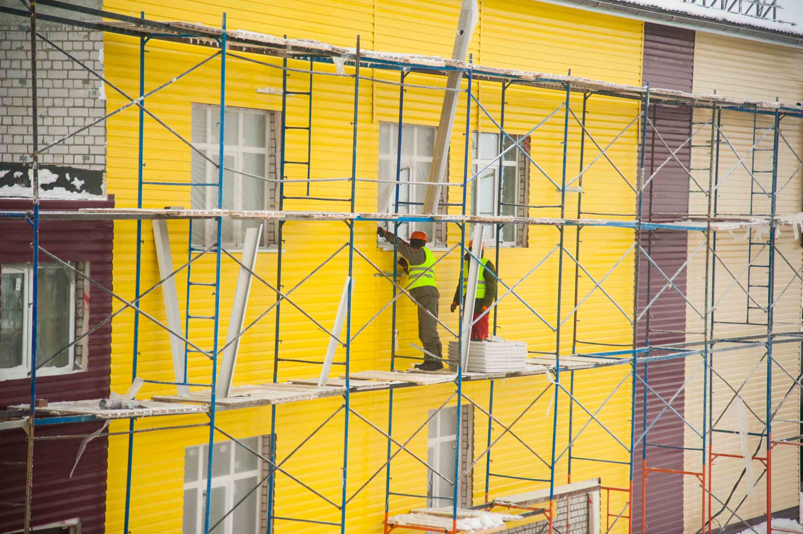 construction-workers-installing-siding-on-building-2026-09-24-22-27-44-utc