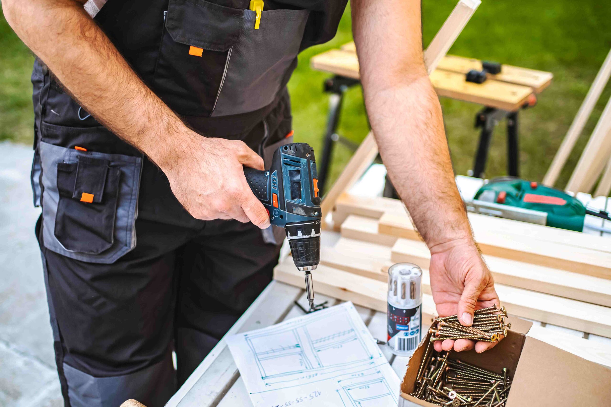 man-working-with-power-drill-outdoors-on-project-2026-09-22-06-31-38-utc